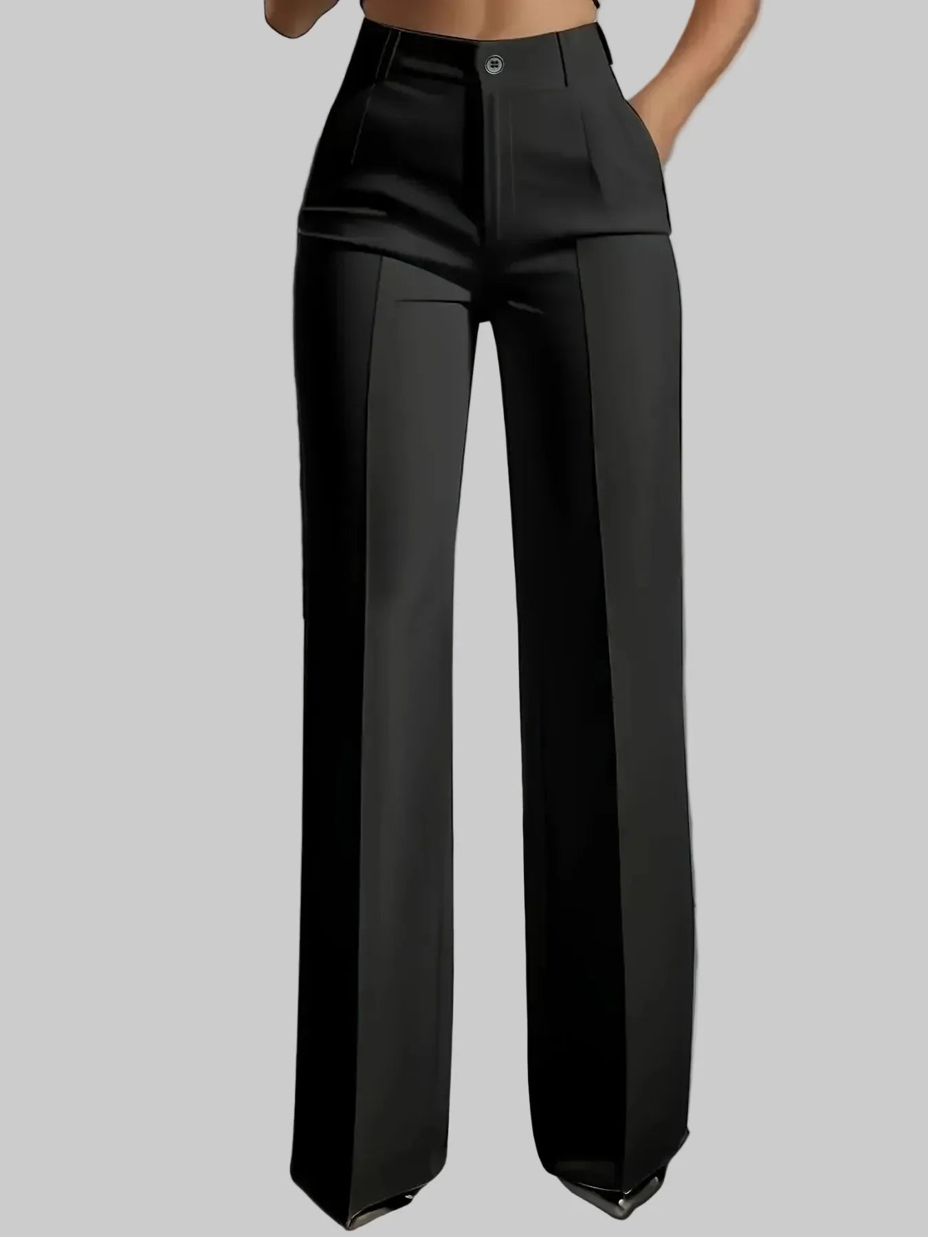Person wearing black wide-leg pants in a minimalistic setting