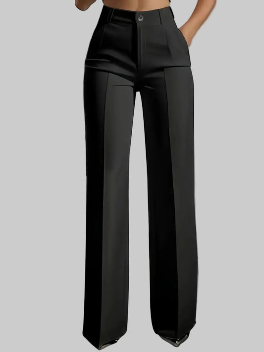 Person wearing black wide-leg pants in a minimalistic setting